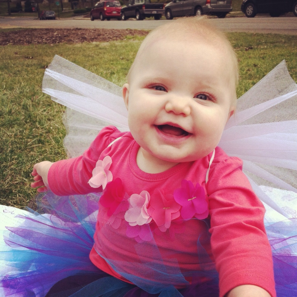 happy baby girl wearing butterfly tutu