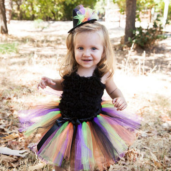 happy baby girl wearing rainbow tutu
